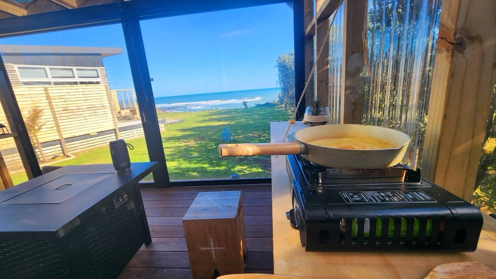 Kitchenette bench with gas cooker looking out to the ocean