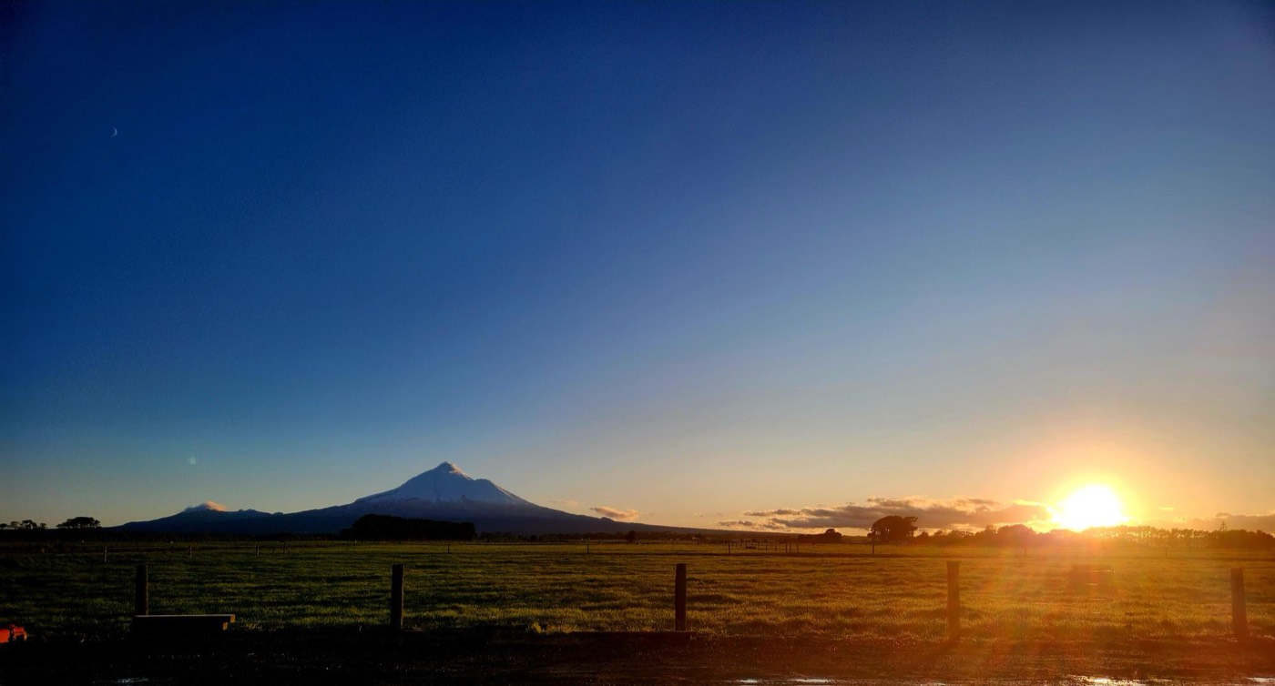 Mount Taranaki across the paddocks at sunrise