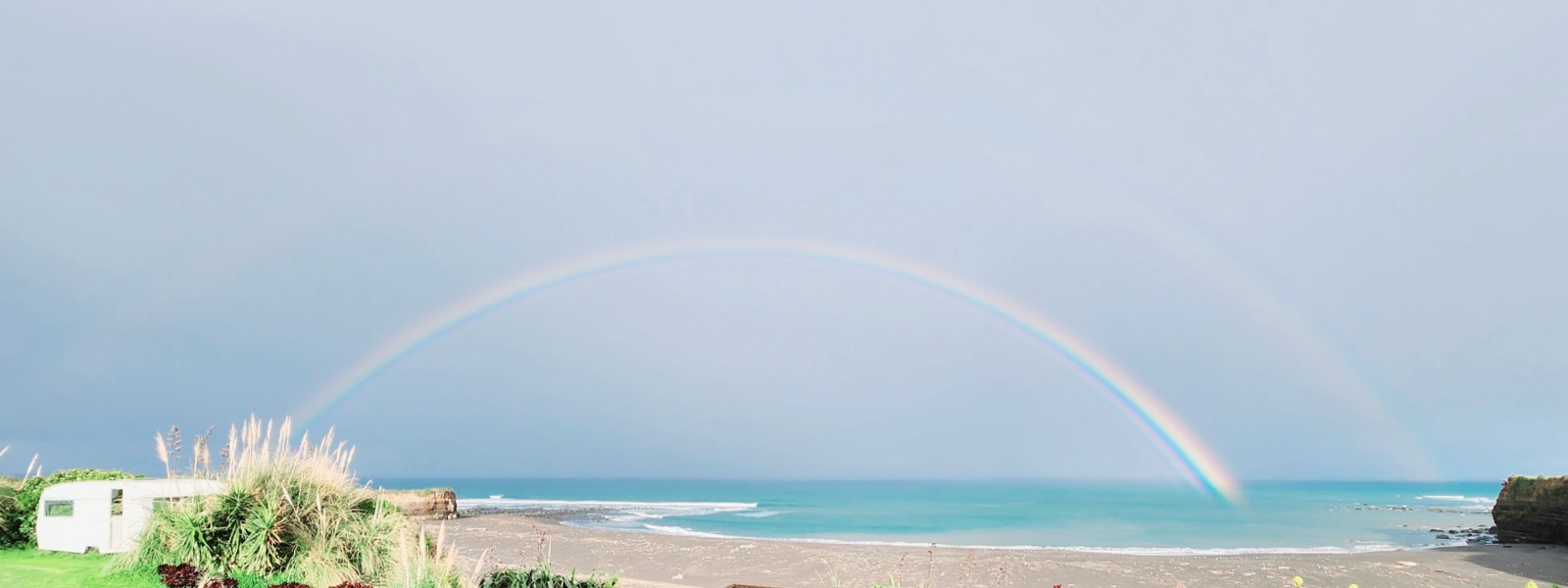 Rainbow over the beach below the cabin