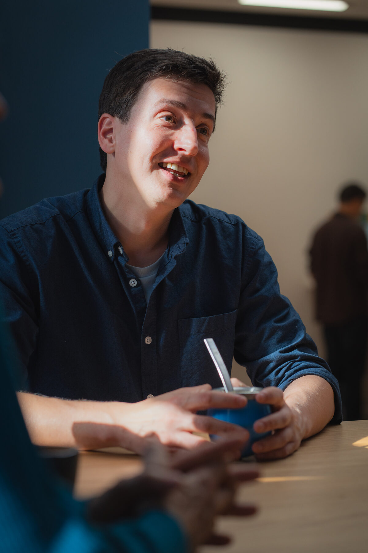 Xavier sharing a laugh over yerba mate at the office